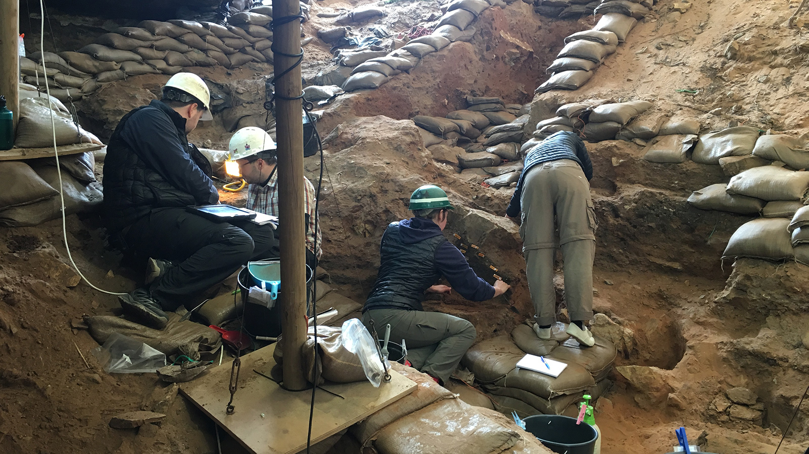 archeologists unearthing something inside a cave 